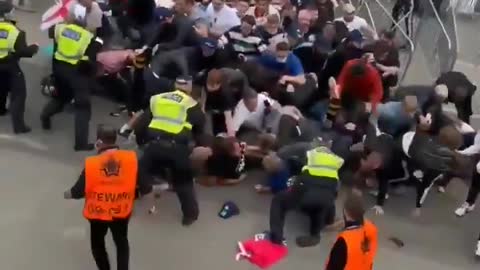 Fans force their way into Wembley before England-Italy is to kick off.