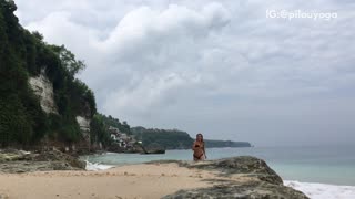 Girl in black swimsuit does cartwheels on the beach and phone gets wet