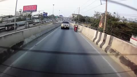 Moped with Two Passengers Goes for a Slide