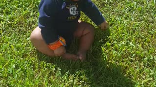 baby touches grass for the first time