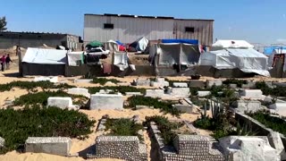 Seeking safety, Gazans reside with dead in cemetery