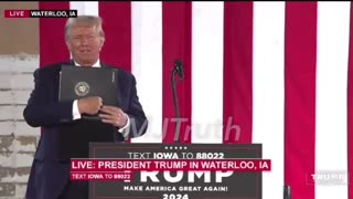 Trump Holds up folder with Presidential Seal that says THE PRESIDENT! also Some Kind of Hand Signal