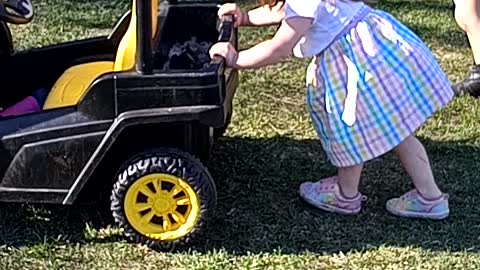 Skyla pushing car around