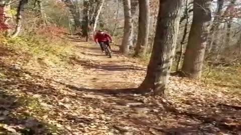 Red sweater bicycle faceplant