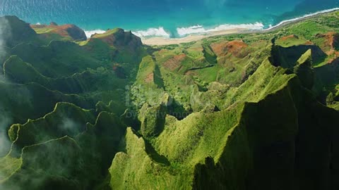 Cinematic aerial view of dramatic mountains and ocean on Napali Coast, Kauai, Hawaii