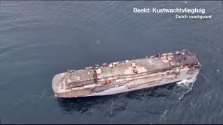 Burned car carrier towed to safety off Netherlands