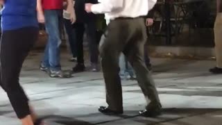 Music older guy dancing outside with people