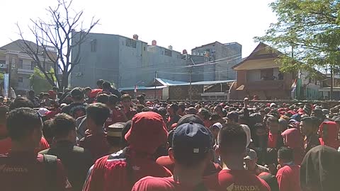 Hundreds of soccer supporters cramped in front of the entry gate