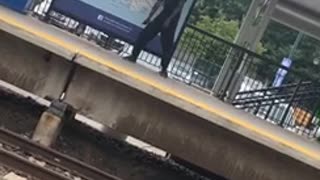 Guy in black outfit dancing on subway platform