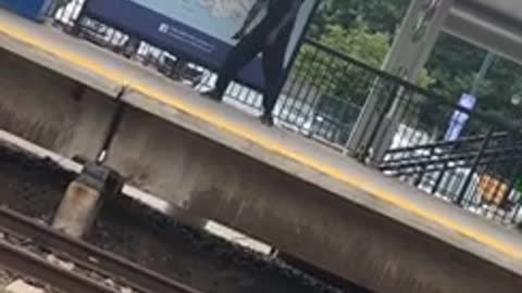 Guy in black outfit dancing on subway platform