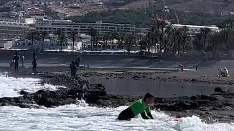 Guy is taken straight to the shore on a surfboard! Cool!