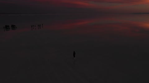 Drone Video of a Man Standing at a Sunset Point