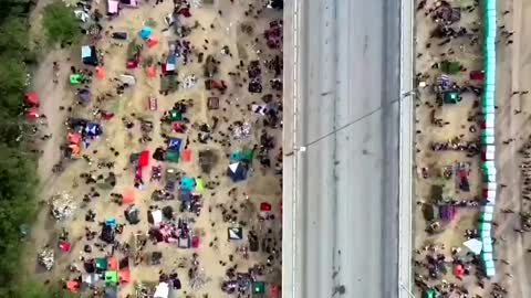 Drone footage shows more than 10,000 migrants,