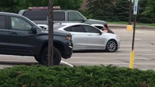 Gutsy Woman Tries to Stop Fleeing Car