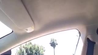 Guy hangs feet out window motorcycle cop sees him