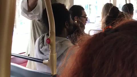 Guy lighting and smoking from a piece on the bus