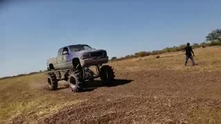 Monster truck hammers camera guy with rocks and dirt