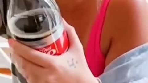 Girl shows a fizzy drink trick and goes wrong and damages her laptop