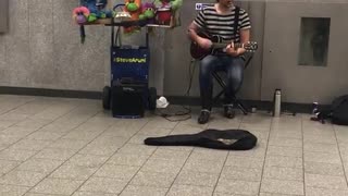 Guy striped shirt singing somewhere over the rainbow green bowls next to him