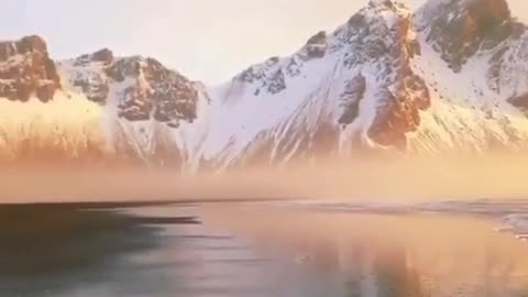 Amazing Beach Surrounded By Mountains Covered By Snow