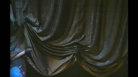 Singing Woman Accidentally Gets Lifted Off The Stage By A Curtain