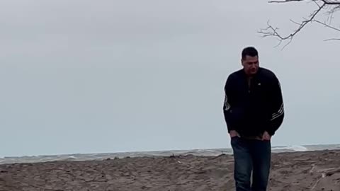 Drunk man falls over during wind storm at beach