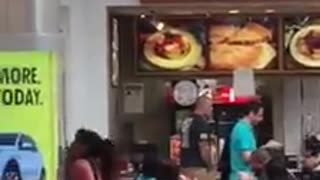 Mouse Scurries on Wall at Mall Food Court