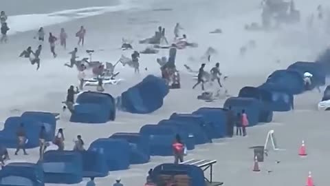 waterspout ripping through crowded beach