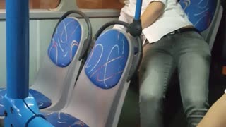 Guy white shirt struggling to stand up on bus