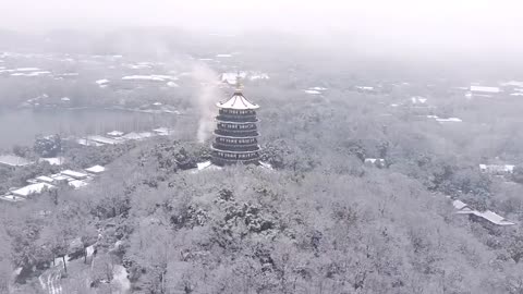 Cooking smoke; Ancient pagoda; snowscape