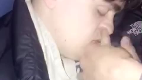 Guy black jacket drunk in sofa eating picking nose