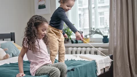 Heartwarming Moments: My Kids Playfully Bonding with Our Adorable Cat in the Bedroom!