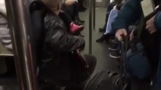 Black jacket guy plays bass and sings on subway