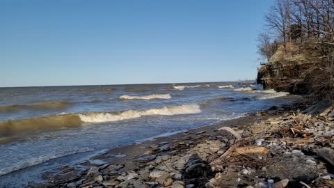 Watch and listen to crashing waves on cliffs