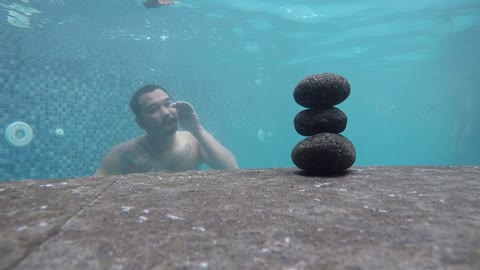 Diver Uses Bubble Ring To Tumble Rocks