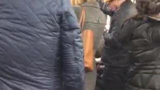 Two men wear the exact same outfit on subway train