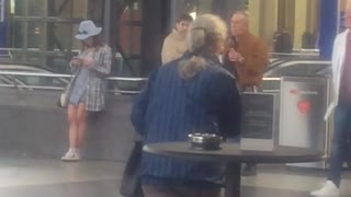 Guy accidentally throws hat off of balcony