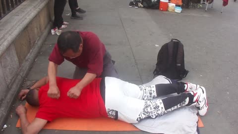 Luodong Massages Latin Man In Red Shirt On Sidewalk