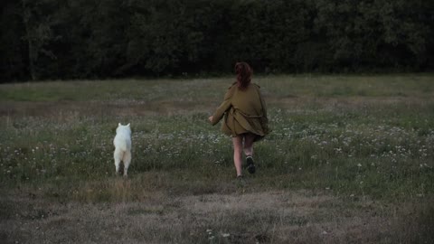 Watch how the girl plays with the dog in the woods