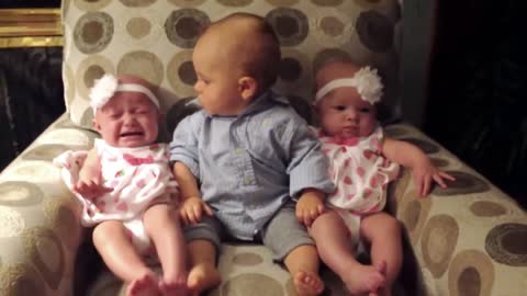 This Baby In Between Identical Twins is BEYOND Confused
