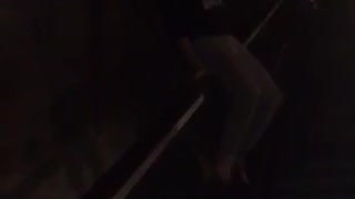 Girl sliding down railing falls down