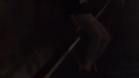 Girl sliding down railing falls down