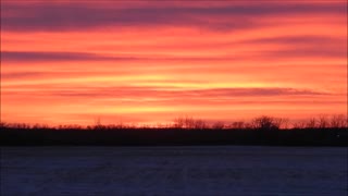 Vibrant Colors Of Exhaust Clouds Spread Across the Prairie Sunset