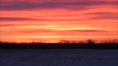Vibrant Colors Of Exhaust Clouds Spread Across the Prairie Sunset