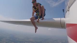 Crazy Skydiver sits on Plane’s Wing Before Jumping Off