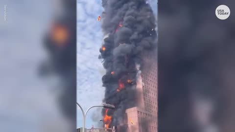 Flames engulf skyscraper in China