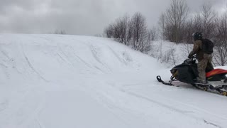 Snowmobile Rider Takes a Spill