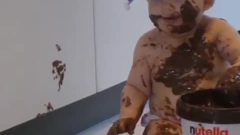 A baby is left alone with a giant tub of Nutella. You can imagine what happens next.