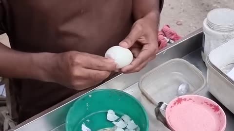 A blind man is selling a very healthy egg milk drink