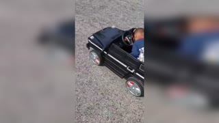 Adorable Tot Asleep At Wheel Of Moving Toy Car